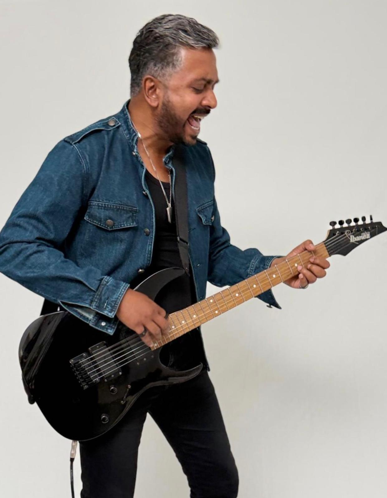 Laji George playing guitar